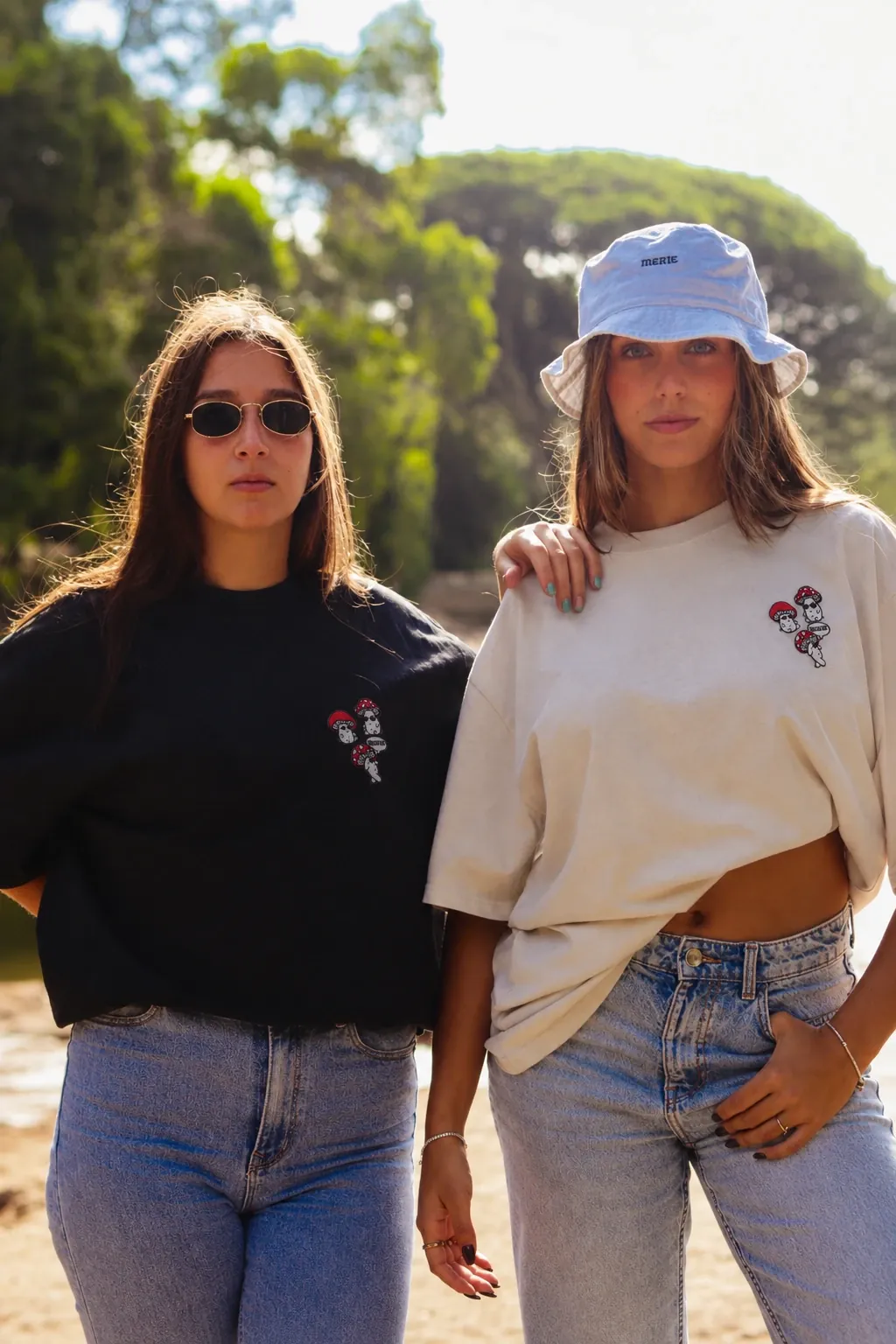 Duas raparigas com as t-shirts Cogumelos preta e khaki